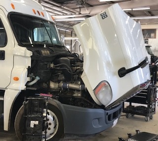 white truck with an open hood
